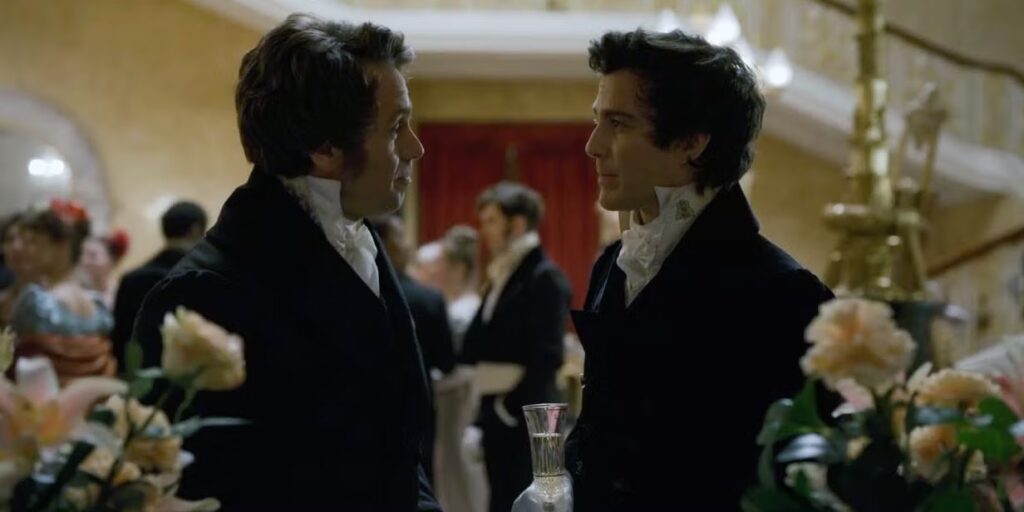 Henry Granville and Lord Wetherby gazing at each other during a party scene in a still from Bridgerton