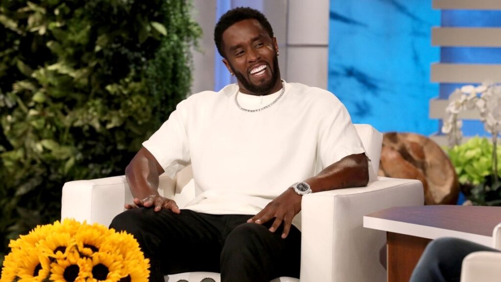Sean Combs Trial: P Diddy Apologized to Jane Because of Cassie Ventura 2 P Diddy aka Sean Combs smiling in a white t-shirt and black trousers during his appearance on Ellen DeGeneres Show