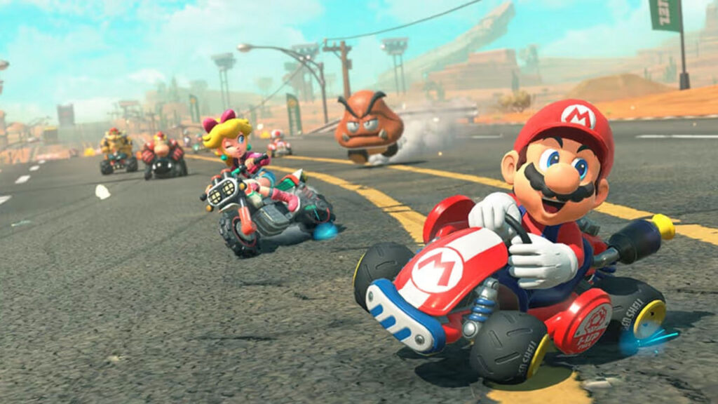 Call Off the Skepticism - Mario Kart World Just Got 10 Hours Deeper Thanks to One Obsessive Racer 12 Mario drifting in Mario Kart World with Princess Peach behind him and a Goomba chasing them.