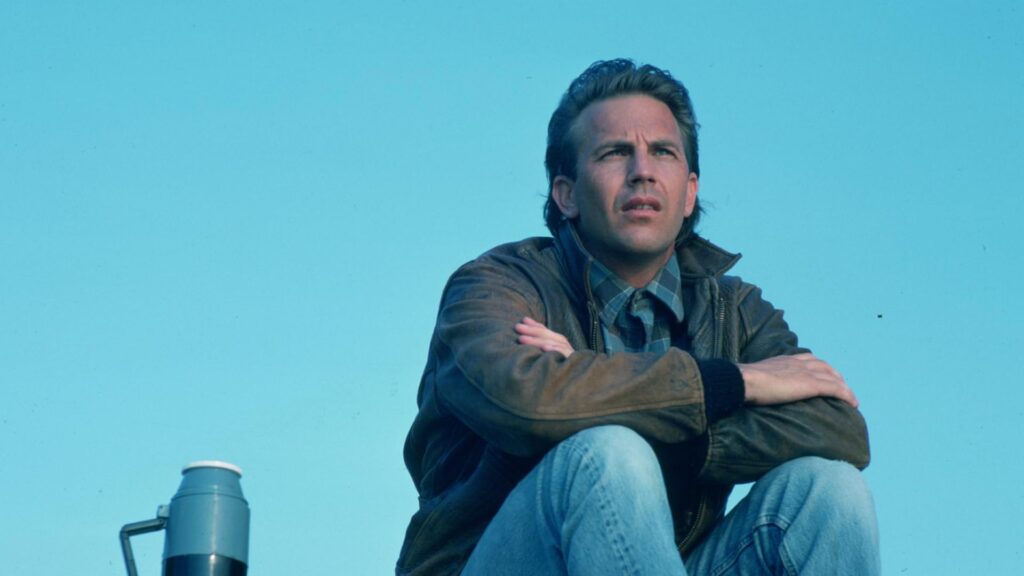Kevin Costner sitting deep in thought in a scene from 'Field of Dreams'