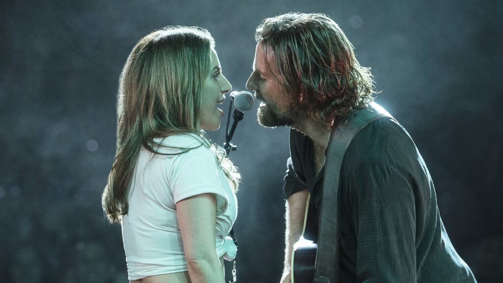 Bradley Cooper and Lady Gaga sing on stage together for a film.