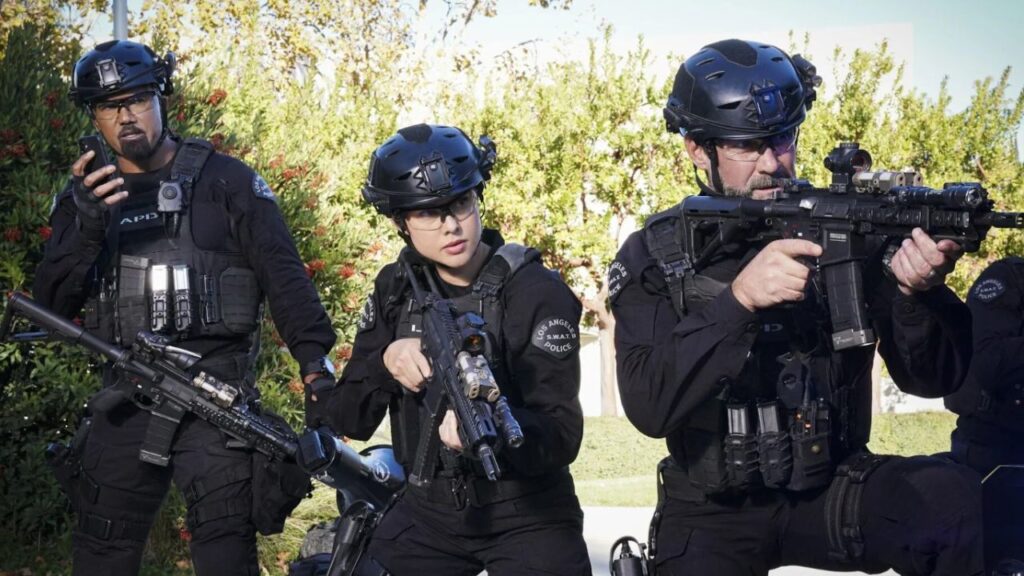 Shemar Moore talking on his walkie talkie and Jay Harrington, and Anna Enger Ritch holding their guns in S.W.A.T.
