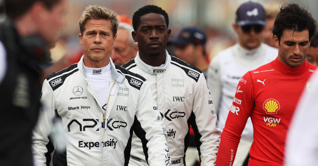 How Is Brad Pitt's F1 Movie: Critic Says It Will Remind You of Tom Cruise's Top Gun Maverick 3 Brad Pitt and Damson Idris walking through a crowd in a still from F1