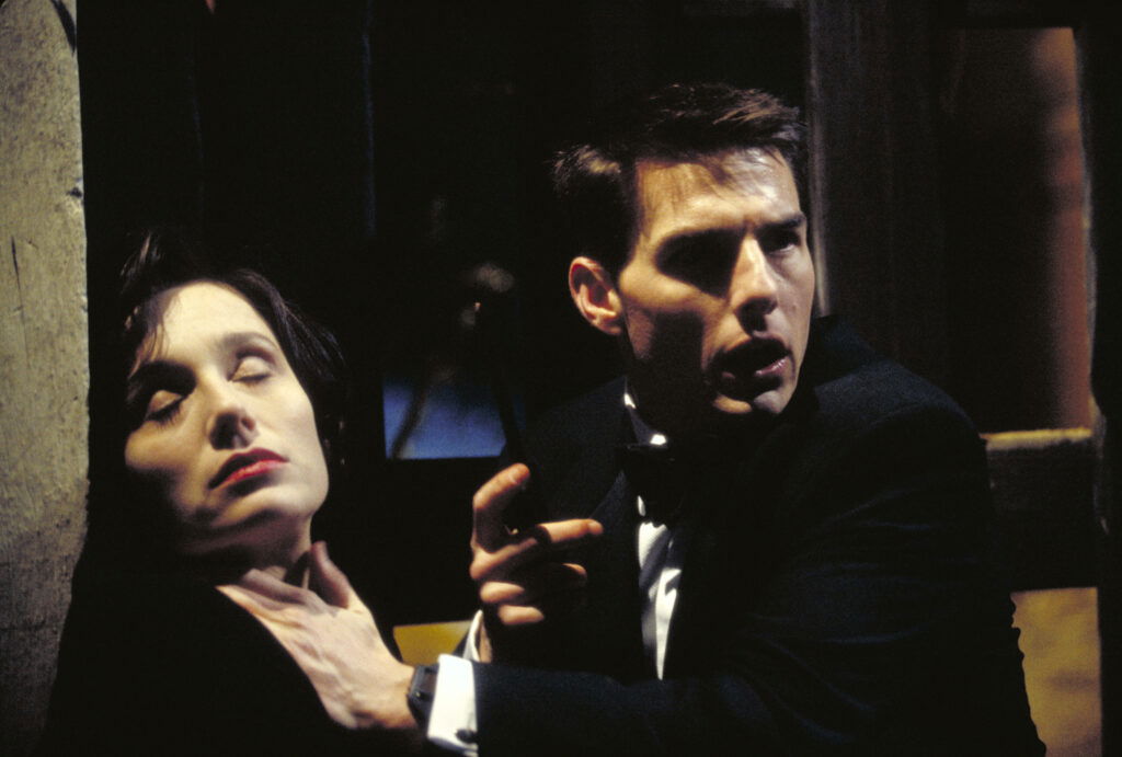 American actor Tom Cruise as Ethan Hunt, discovering the body of his murdered colleague, played by actress Kristin Scott Thomas, in a scene from the film 'Mission: Impossible', 1996.