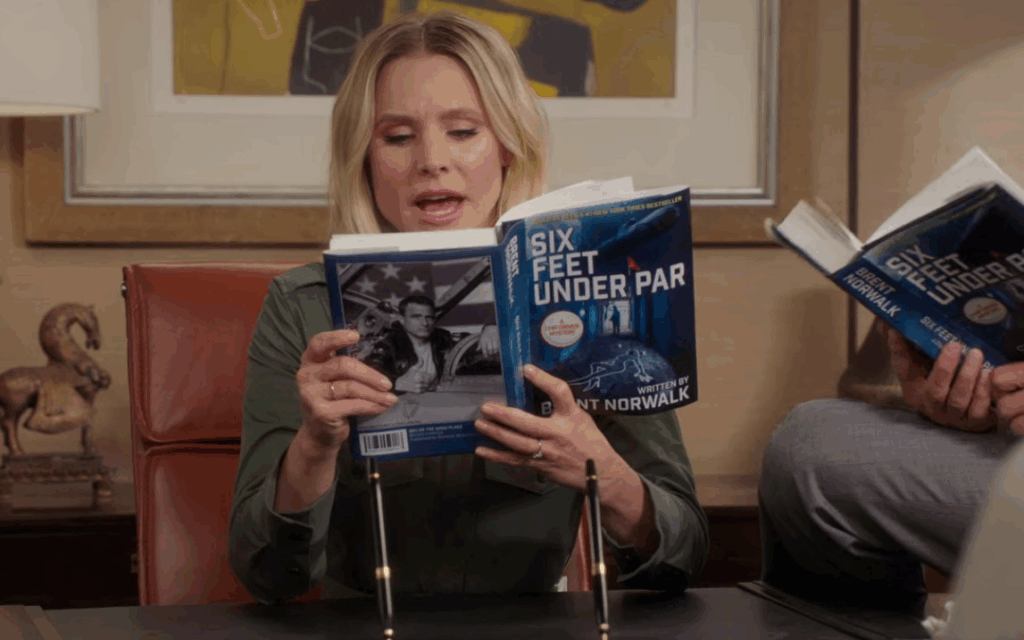 Mike Schur Is a Genius for ‘The Good Place’ Satirizing Men Writing Women in Its Greatest Scene of the Show 1 Eleanor reading Brent's book in The Good Place episode