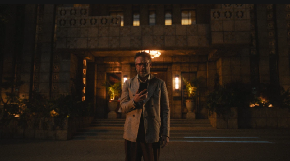 20 Absolutely Best TV Shows to Watch Right Now (June 2025) 1 Matt Remick is standing on the road. He is staring at his mobile with disbelief.