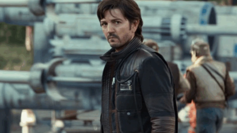 20 Absolutely Best TV Shows to Watch Right Now (June 2025) 6 Cassian Andor stands in front of a large ship, looking serious and alert.