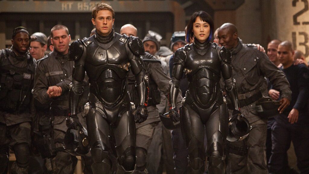 12 Best Guillermo del Toro Movies to Watch Before ‘Frankenstein’ on Netflix 6 Charlie Hunnam and Rinko Kikuchi as Raleigh and Mako in a sequence of Pacific Rim walking down a corridor.