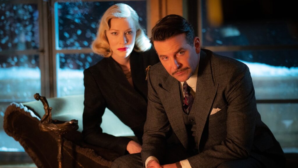 12 Best Guillermo del Toro Movies to Watch Before ‘Frankenstein’ on Netflix 11 Cate Blanchett and Bradley Cooper as Lilith and Stanton in Nightmare Alley sitting and leaning over.