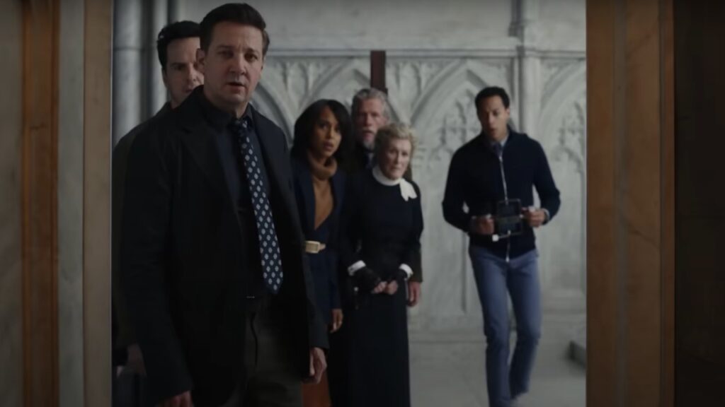 The cast of Wake Up Dead Man: A Knives Out Mystery in a still looking from behind a door