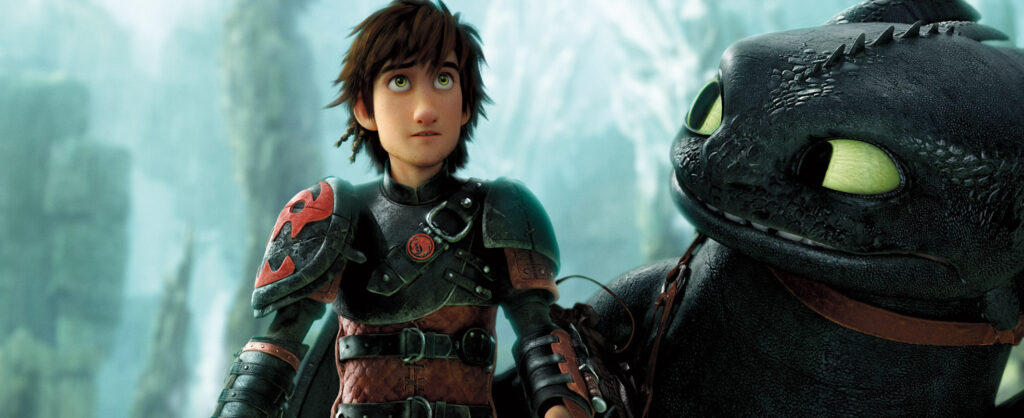 How To Train Your Dragon Post-Credits Scene EXPLAINED: A Hint at a Sequel? 5 A still from How To Train Your Dragon 2 featuring Hiccup standing next to Toothless with several rock towers in the background.