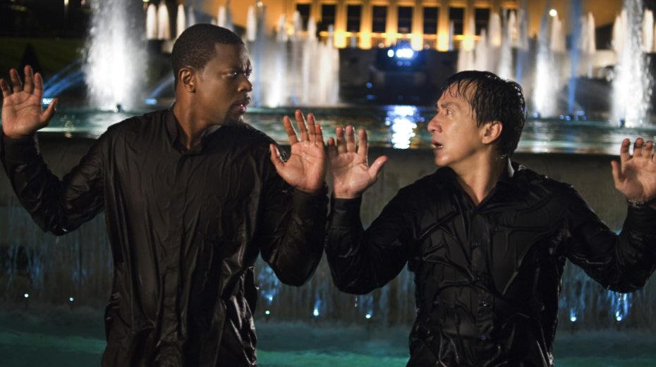 Lee and Carter are both drenched, their hands raised in surrender. They look at each other in shock.