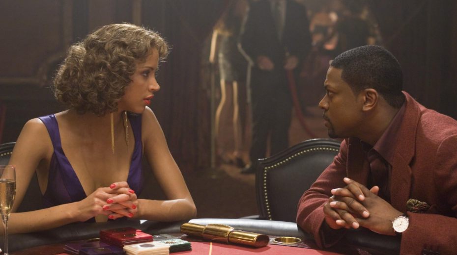 Carter is sitting across the table from Genevieve, leaning slightly forward.