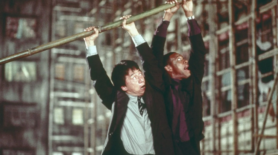 Both Lee and Carter are hanging from a pole high above the ground, looking scared but trying to hold on.