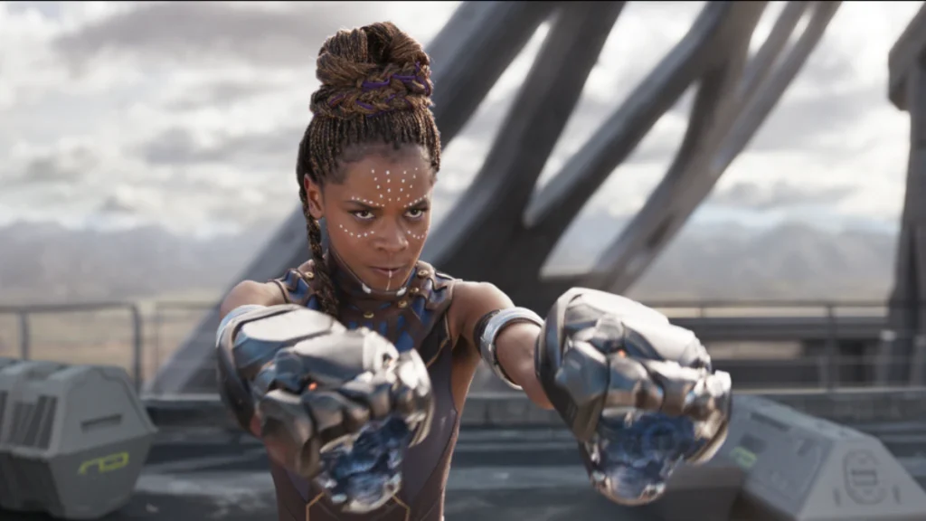 Ryan Gosling Is the Next Black Panther Rumors Debunked 4 Shuri points her metal hand gear at a distance with a serious expression