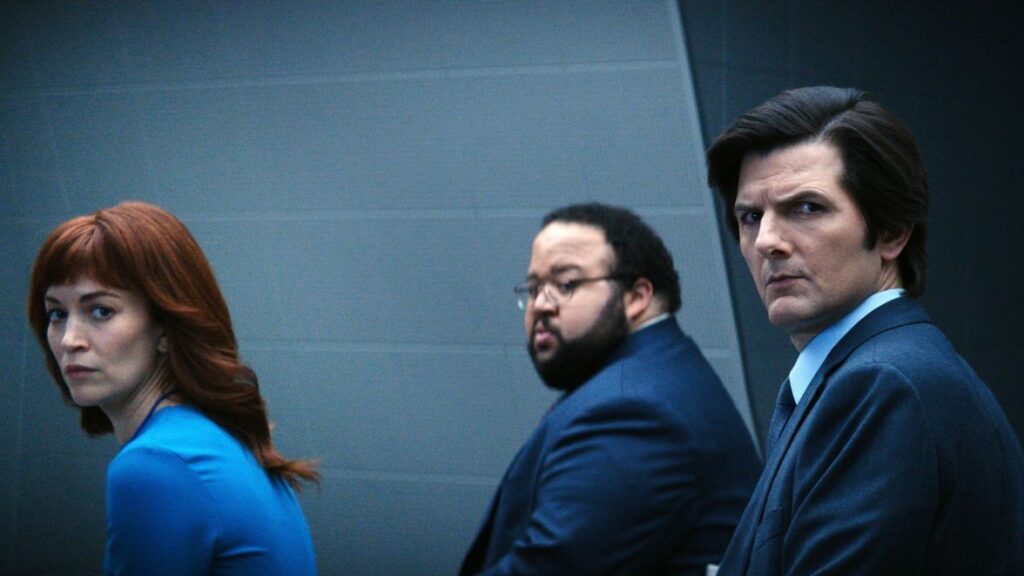 20 Absolutely Best TV Shows to Watch Right Now (June 2025) 52 Helly, Dylan, and Mark sitting the the office, looking towards the camera with confused expressions.