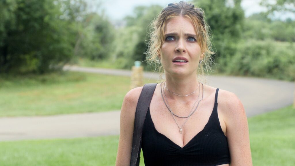 20 Absolutely Best TV Shows to Watch Right Now (June 2025) 82 Devon DeWitt (Meghann Fahy) with her hair pulled back wearing a black tank top stands outdoors with a concerned or distressed expression.