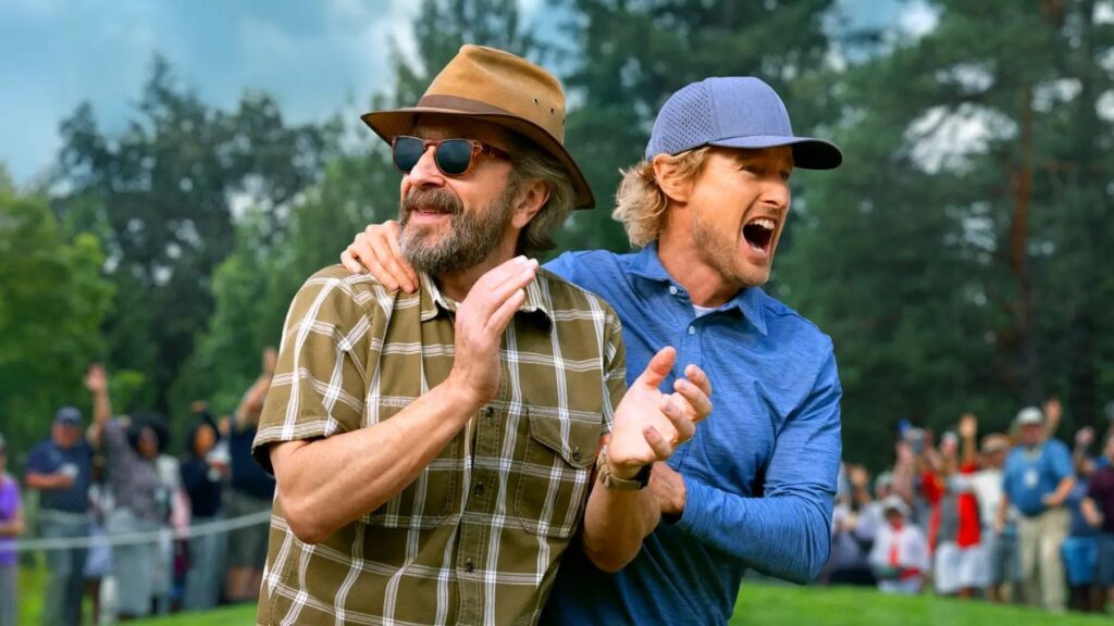 20 Absolutely Best TV Shows to Watch Right Now (June 2025) 88 Mitts (Marc Maron) and Pryce Cahill (Owen Wilson) celebrating on a golf cours, both appearing jubilant with a crowd in the background.