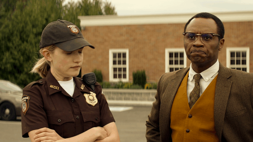 20 Absolutely Best TV Shows to Watch Right Now (June 2025) 94 Roscoe Conklin in uniform with a cap stands next to Oscar Finlay in a brown suit vest and glasses in front of a brick building.