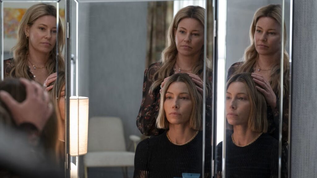 20 Absolutely Best TV Shows to Watch Right Now (June 2025) 100 Multiple reflections of Nicky Macintosh (Elizabeth Banks) and Chloe Taylor (Jessica Biel) - Nicky in a floral top and Chloe in black - shown in a three-way mirror.