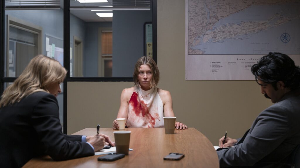 20 Absolutely Best TV Shows to Watch Right Now (June 2025) 97 Chloe Taylor (Jessica Biel) in a white top covered with red stains sits at an interrogation table, facing two detectives in a police station interview room.