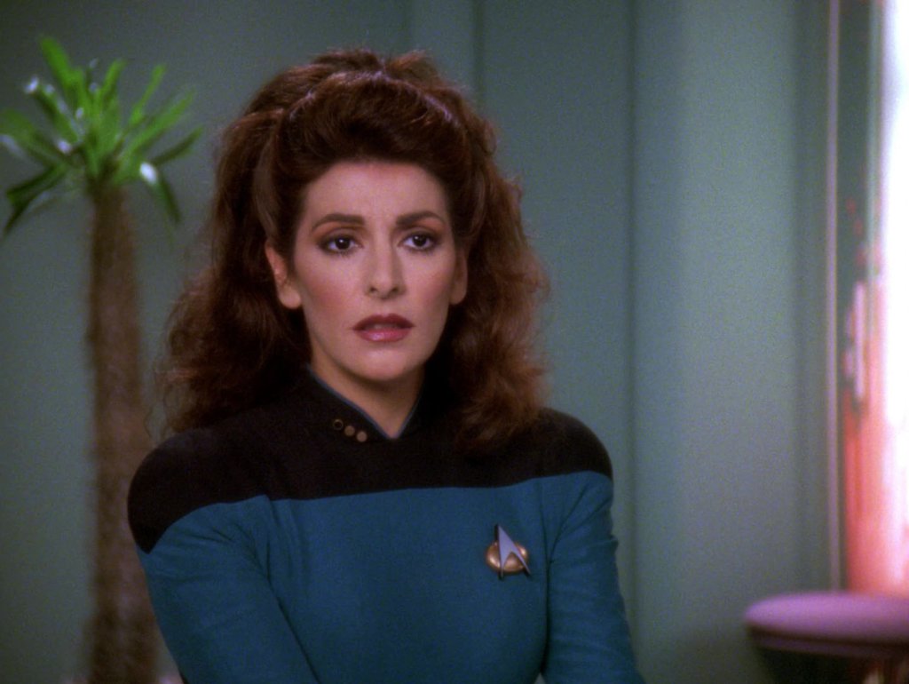 ‘Star Trek: The Next Generation’ Cast: What Are They Doing in 2025? 3 Counselor Deanna Troi in her blue Star Trek uniform talking to someone.