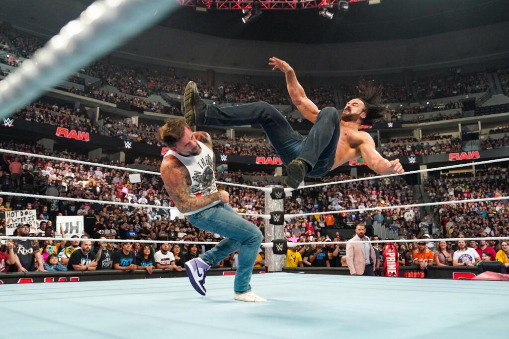 Drew McIntyre attacking CM Punk. 