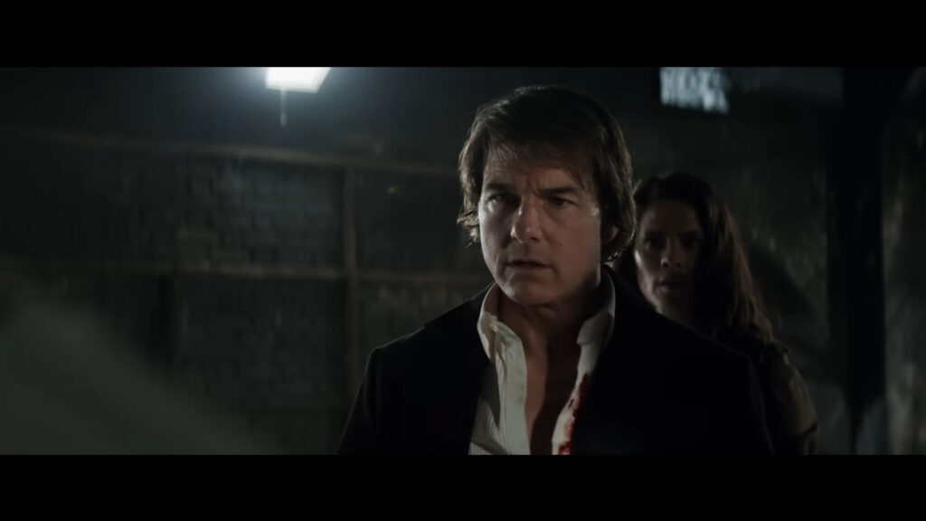 Are Tom Cruise and Ana De Armas Dating? All You Need to Know 1 Tom Cruise looking below with a shocked expression inside a dark room