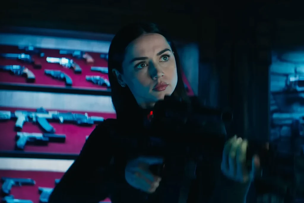 Are Tom Cruise and Ana De Armas Dating? All You Need to Know 2 Ana de Armas holding a machine gun and pointing at a target