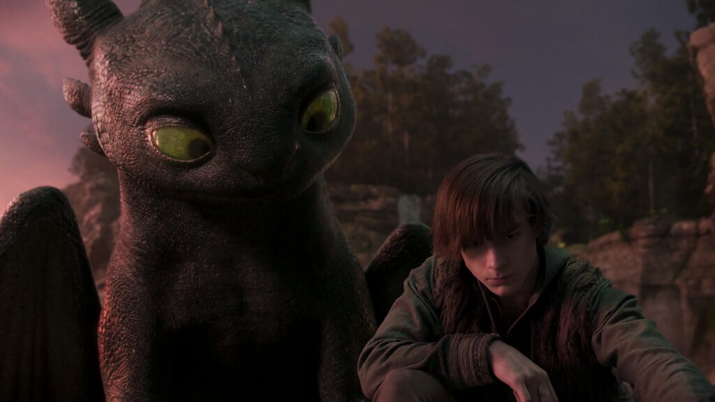 How to Train Your Dragon Review — A Majestic and Heartwarming Family Adventure 11 A dragon looks over the shoulder of a boy