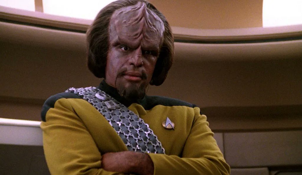 ‘Star Trek: The Next Generation’ Cast: What Are They Doing in 2025? 6 Lieutenant Commander Wolf listening to someone in Star Trek: TNG.