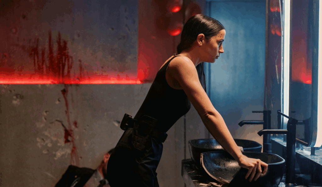 ‘Ballerina’ Box Office: Ana de Armas Scores the Third-Biggest Collection for Any ‘John Wick’ Movie in History 9 Eve Macarro is standing in a dim, blood-smeared bathroom, looking tense and serious.