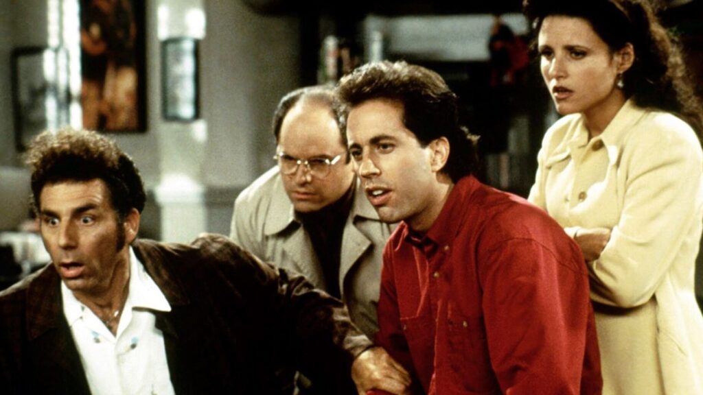 10 Insanely Popular TV Shows From the ‘90s You Can Stream on Netflix 3 A Seinfeld scene with the main characters in what appears to be a tense or dramatic moment, showing the ensemble cast's chemistry and the show's signature New York apartment setting.