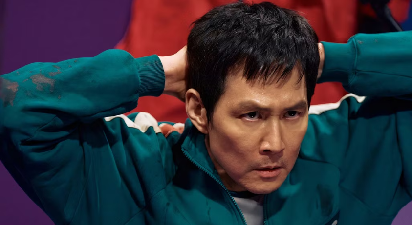 What You Need to Know About Player 456 Ahead of ‘Squid Game’ Season 3 5 Seong Gi-hun has his hands behind his head, looking serious and focused.
