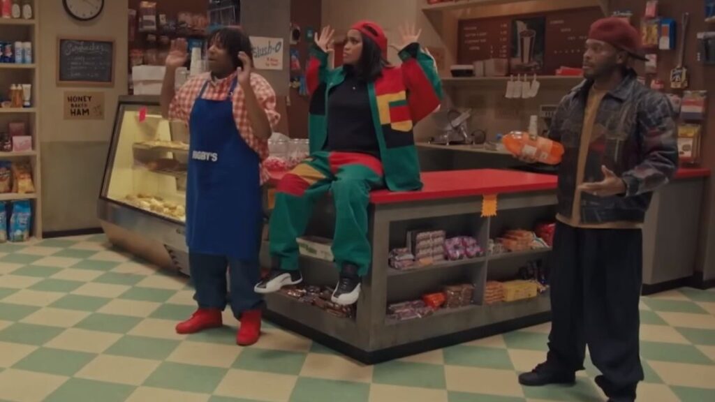 10 Insanely Popular TV Shows From the ‘90s You Can Stream on Netflix 9 Scene from Kenan & Kel showing three characters in Rigby's grocery store, with Kenan wearing an employee apron.