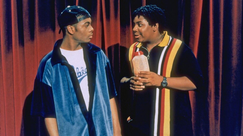 10 Insanely Popular TV Shows From the ‘90s You Can Stream on Netflix 8 Kenan and Kel in their iconic '90s streetwear standing in front of orange curtains.