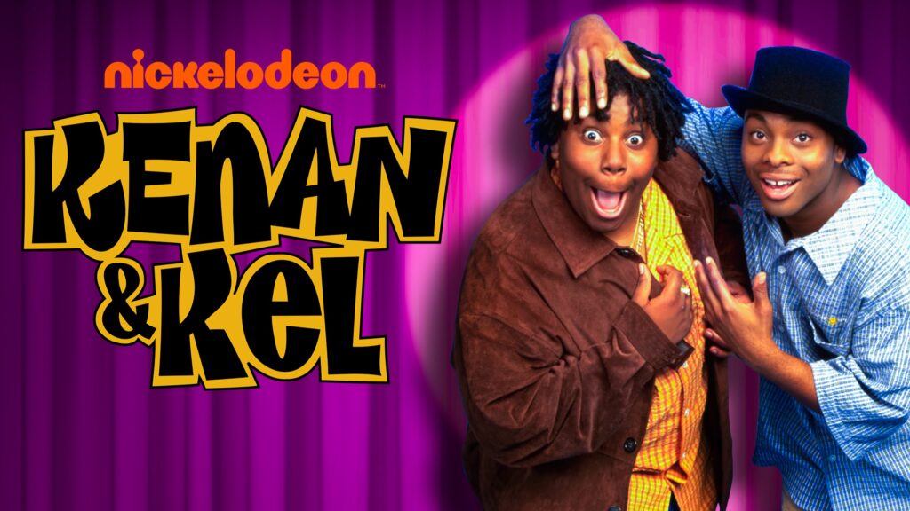 10 Insanely Popular TV Shows From the ‘90s You Can Stream on Netflix 6 Kenan & Kel promotional image featuring the two young stars in colorful '90s outfits against a purple curtain backdrop, with the Nickelodeon logo and show title prominently displayed.
