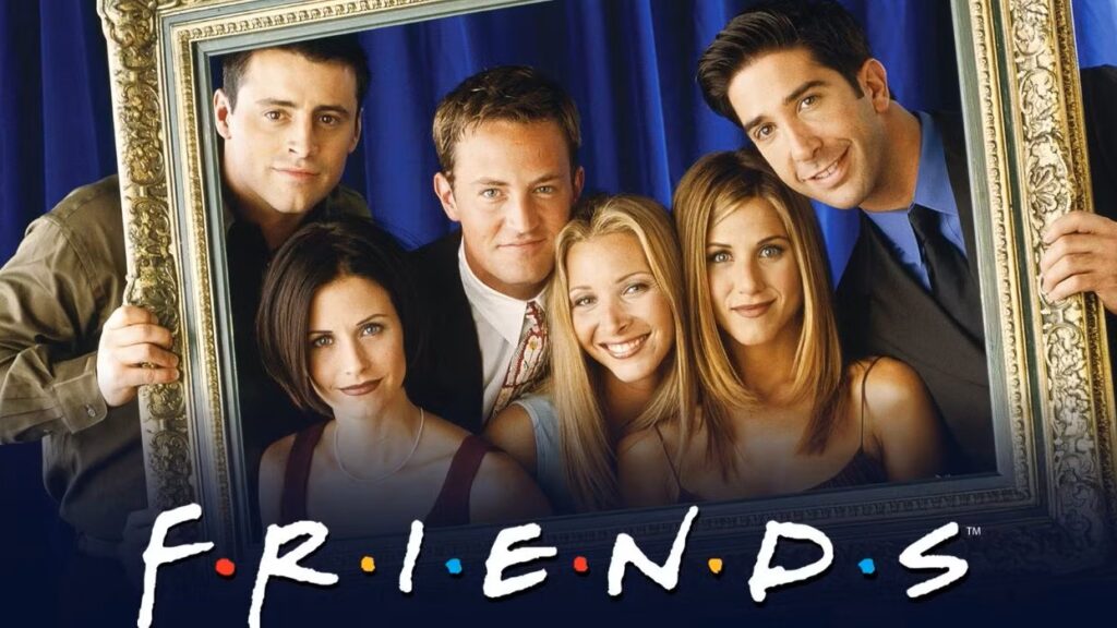 10 Insanely Popular TV Shows From the ‘90s You Can Stream on Netflix 16 Friends promotional photo showing all six main cast members posing together within an ornate picture frame against a blue background, with the show's iconic logo.