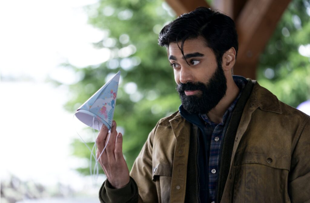 Ginny & Georgia’s Most Anticipated Hookup Was “Rewarding” for Raymond Ablack After a 5-Year Delay 3 Raymond Ablack as Joe holding a birthday cap in his hands on Ginny & Georgia.