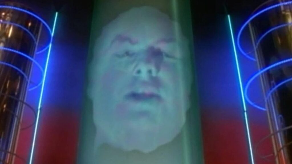 10 Insanely Popular TV Shows From the ‘90s You Can Stream on Netflix 29 Scene from "Mighty Morphin Power Rangers" showing Zordon's floating head image surrounded by blue energy effects in the Command Center's viewing tube.