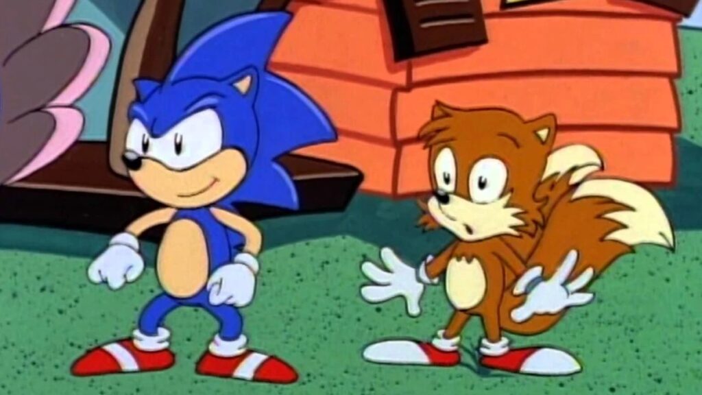10 Insanely Popular TV Shows From the ‘90s You Can Stream on Netflix 42 Animation still from "Adventures of Sonic the Hedgehog" showing Sonic and Tails characters standing together outdoors in front of some buildings.