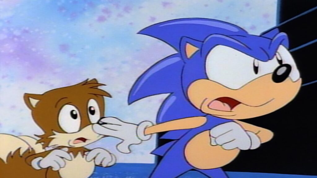 10 Insanely Popular TV Shows From the ‘90s You Can Stream on Netflix 44 Animation scene from "Adventures of Sonic the Hedgehog" featuring Sonic and Tails characters against a cloudy purple-blue sky background.