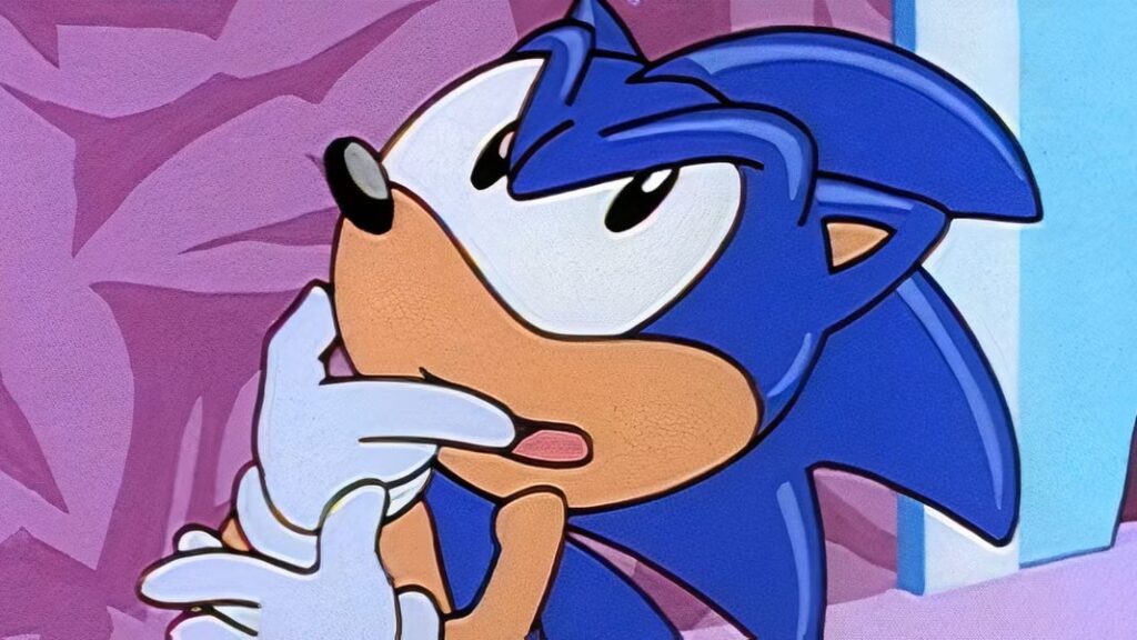 10 Insanely Popular TV Shows From the ‘90s You Can Stream on Netflix 45 Close-up animation still from "Adventures of Sonic the Hedgehog" showing Sonic the Hedgehog's face with his mouth open, appearing to be speaking or reacting to something, against a purple background.