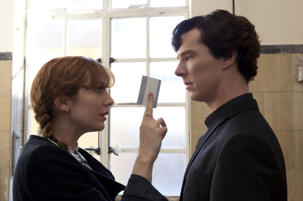 “The f—kable girl with a comic timing”: Harry Potter Star Katherine Parkinson Reveals Why ‘The IT Crowd’ Makes Her Cringe 2 Katherine Parkinson giving a card to Benedict Cumberbatch in a still from Sherlock.