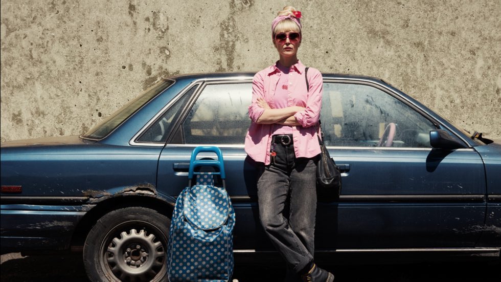 Is ‘Tow’ a True Story? Rose Byrne Admits the Movie Was Filmed in Record Time With “Very little money” 1 Rose Byrne as Amanda in a still from Tow, standing beside her car.