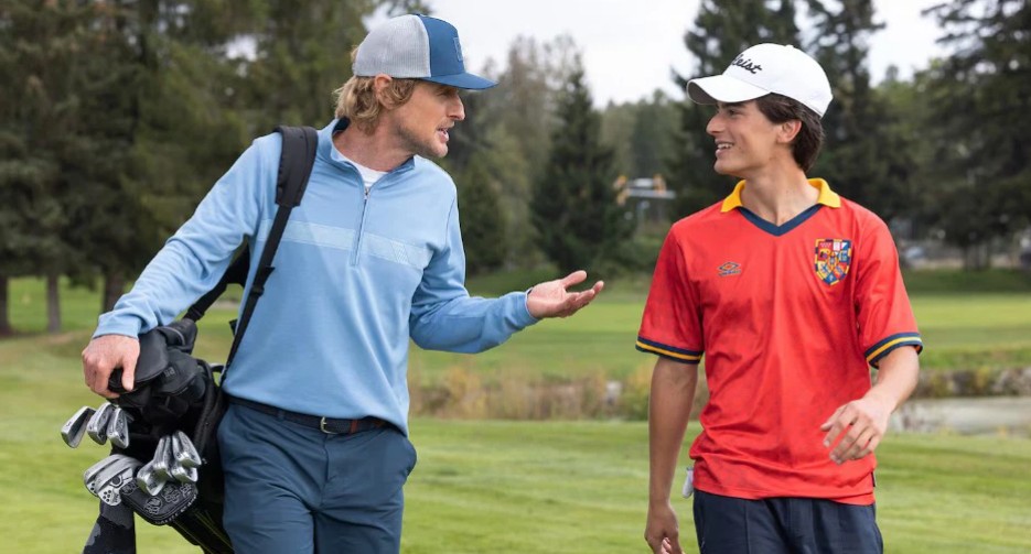 ‘Stick’ Episode 4 Review: Golf Can Wait - This Episode’s All About Ghosts You Can’t Outdrive 4 Owen Wilson and Peter Dager laughing and talking in a playground scene from Stick.