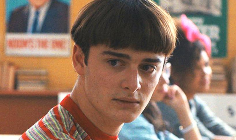 How Old Is ‘Stranger Things’ Cast: Actors’ Age in Season 1 and Season 5 3 Will Byers with a bowl haircut and a striped shirt is looking at someone.
