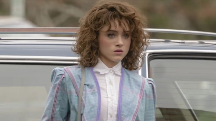 How Old Is ‘Stranger Things’ Cast: Actors’ Age in Season 1 and Season 5 7 Nancy Wheeler is wearing a white ruffled shirt under a pastel plaid jacket. She is looking off to the side with a serious expression