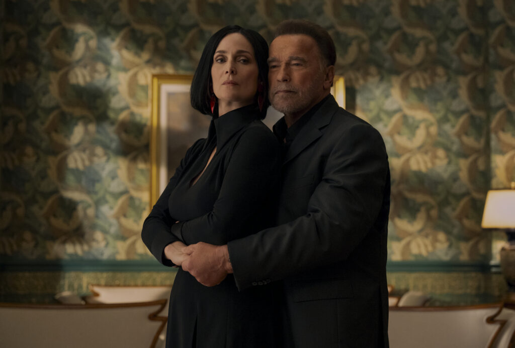 FUBAR Season 2 Review — The Action Falters and the Comedy Flops 8 Fubar. (L to R) Carrie-Anne Moss as Greta Nelso, Arnold Schwarzenegger as Luke Brunner in episode 202 of Fubar. Cr. Christos Kalohoridis/Netflix © 2025