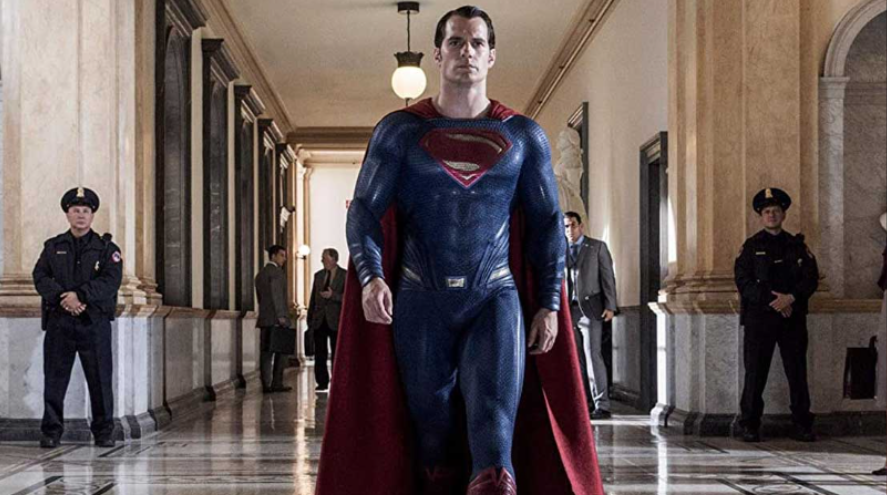 Superman is confidently walking down a grand hallway.